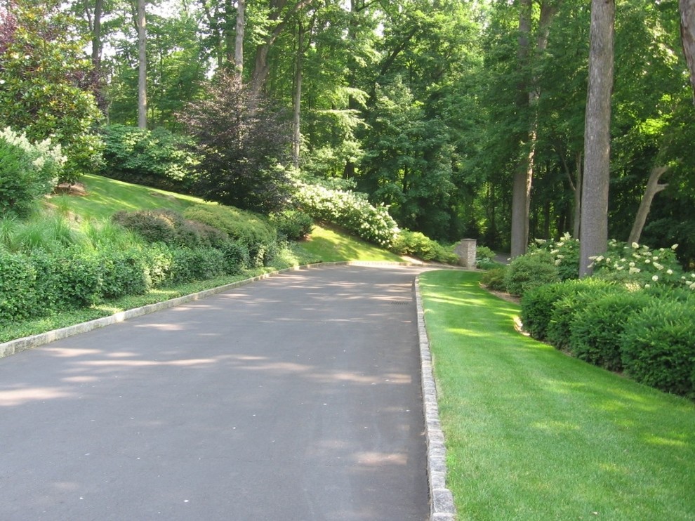 Inspiration for a traditional sloped garden in New York with a garden path and natural stone paving.