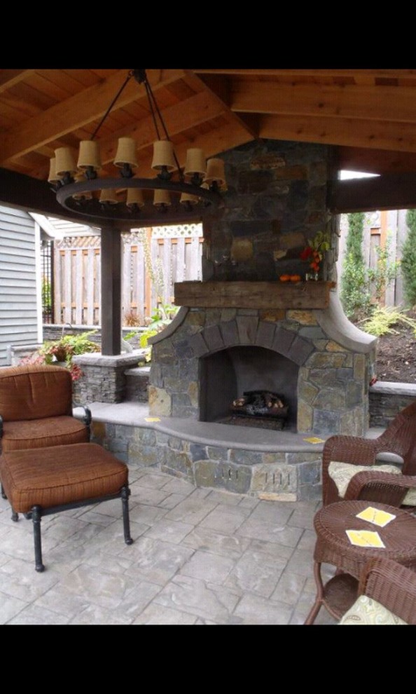 Design ideas for a mid-sized traditional shade backyard stone landscaping in Portland with a fire pit for winter.
