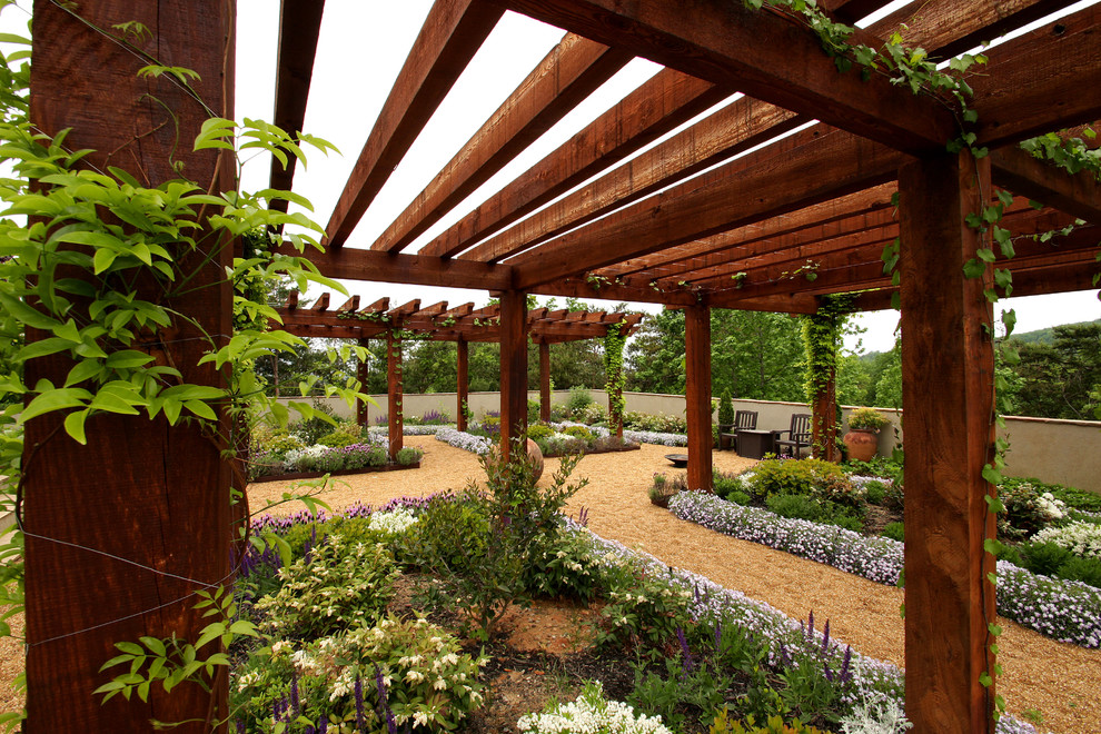 Photo of a large world-inspired back formal partial sun garden for summer in Other with a garden path and gravel.