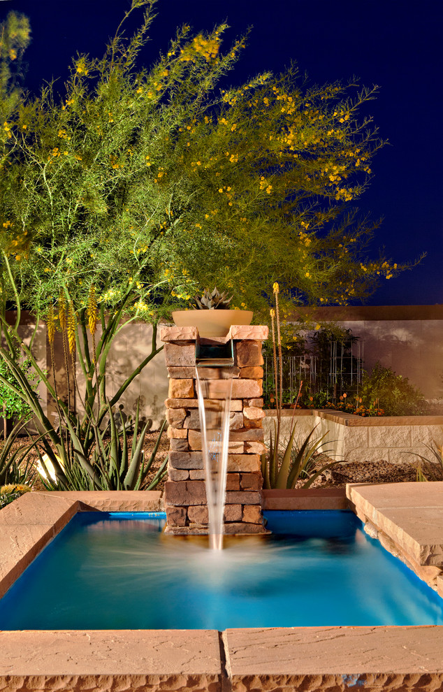 Design ideas for a large classic back partial sun garden for summer in Phoenix with a water feature and concrete paving.