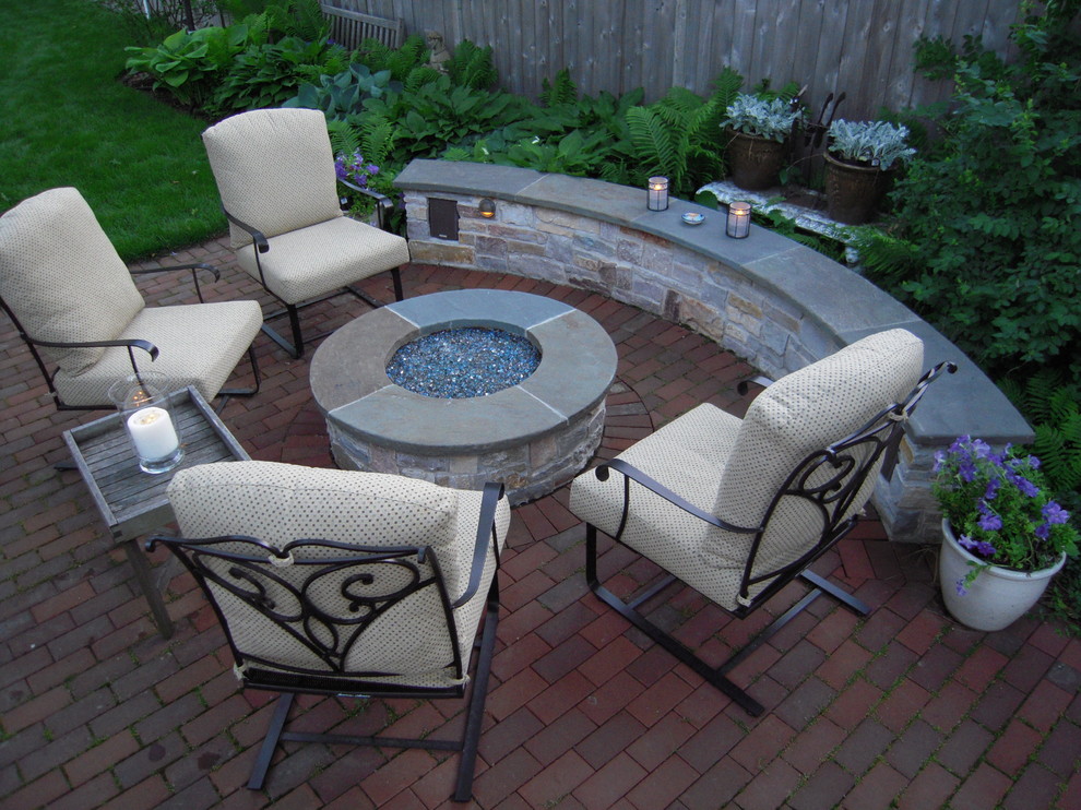 Inspiration for a mid-sized transitional backyard brick patio remodel in Chicago with a fire pit