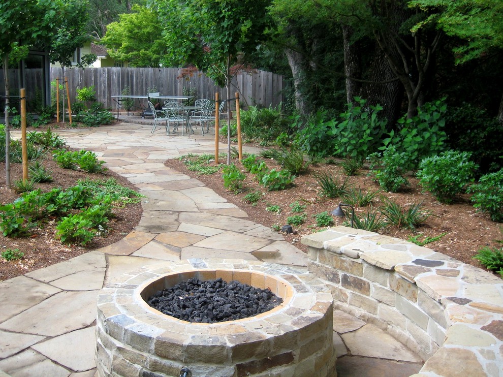 Cette photo montre un grand jardin arrière tendance au printemps avec un foyer extérieur, une exposition ombragée et des pavés en pierre naturelle.