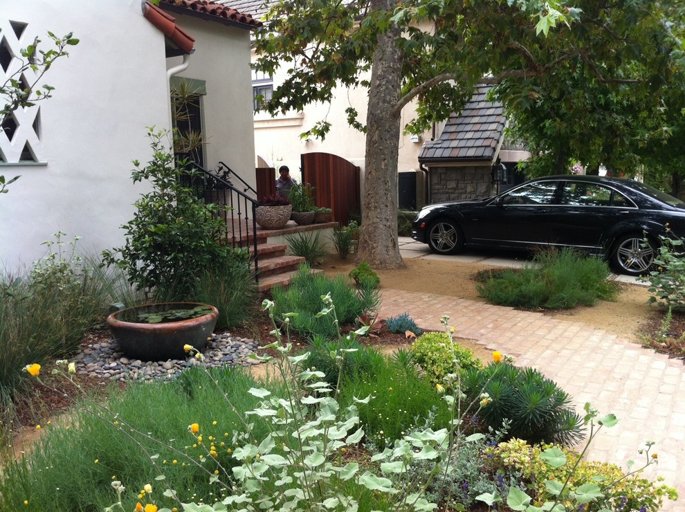Inspiration for a mediterranean front yard brick landscaping in Los Angeles.