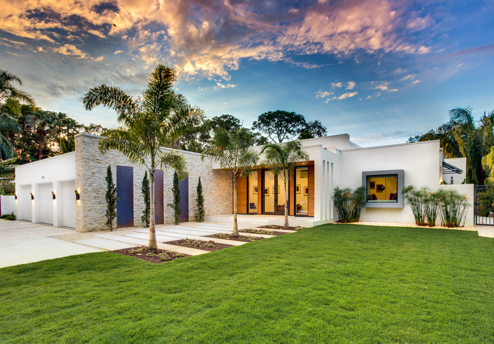 Inspiration for a large contemporary full sun front yard concrete paver garden path in Tampa.