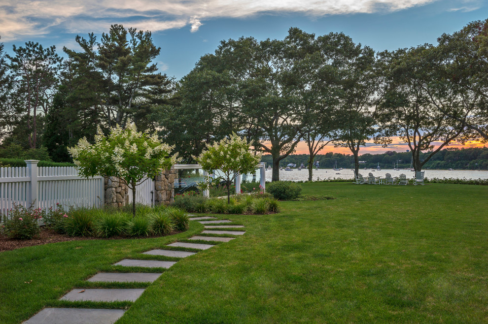 Inspiration for a large coastal full sun backyard stone landscaping in Boston.