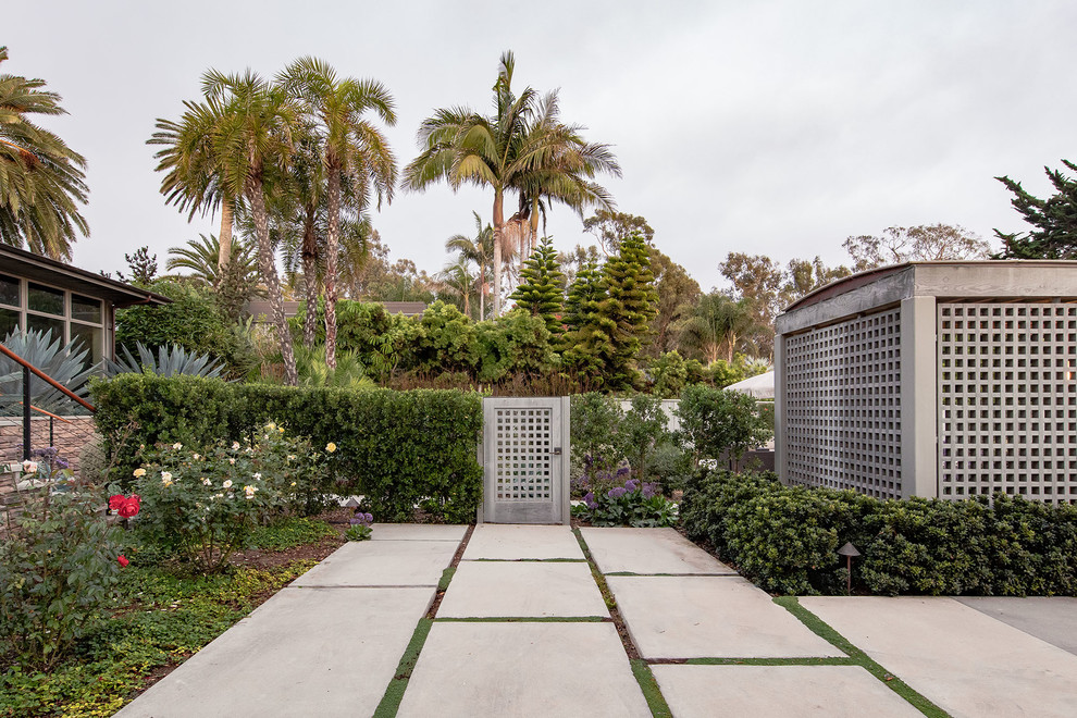 Contemporary back xeriscape garden in Santa Barbara with concrete paving.