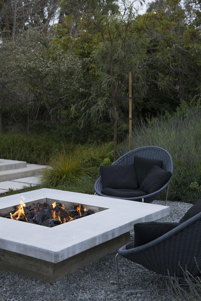 Design ideas for a large contemporary back full sun garden in Los Angeles with a fire feature and gravel.