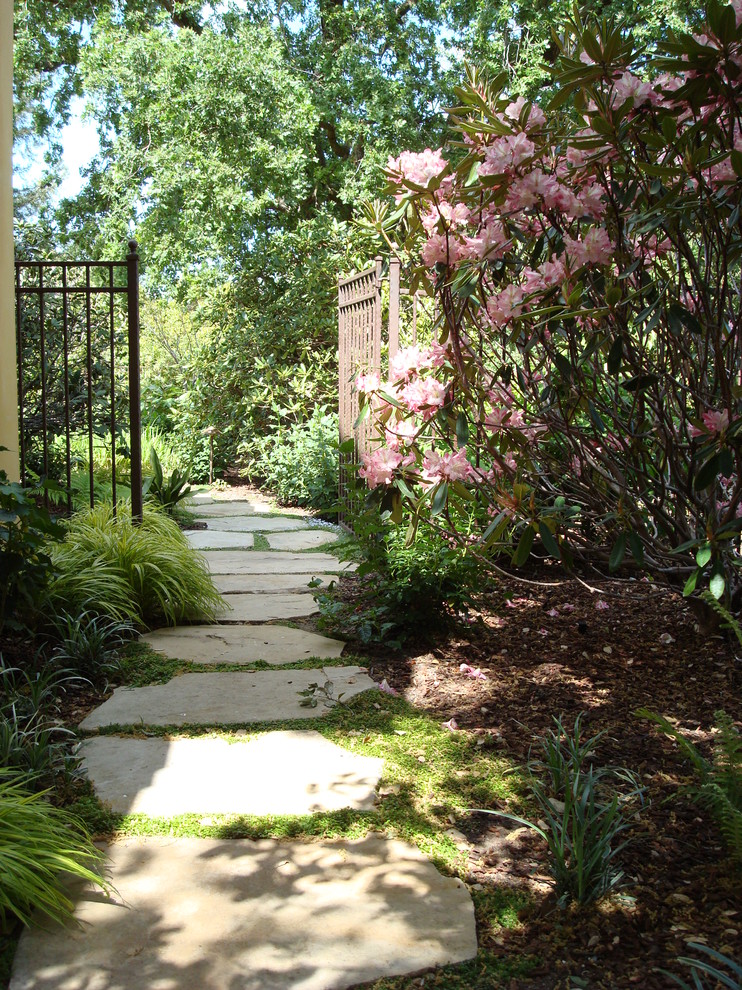 This is an example of a large transitional partial sun side yard stone garden path in San Francisco.