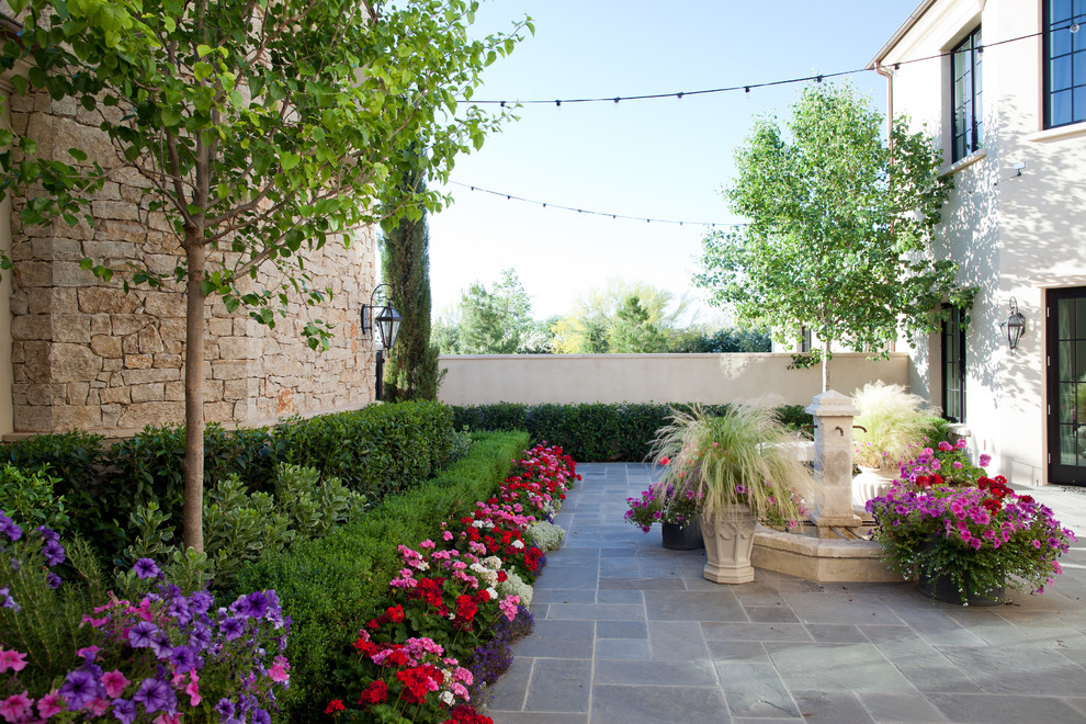 Photo of a traditional courtyard garden in Phoenix with a water feature.
