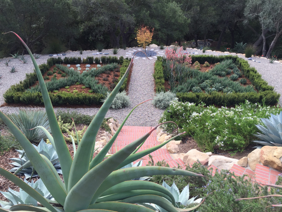 Design ideas for a large mediterranean back formal full sun garden for autumn in Santa Barbara with gravel.