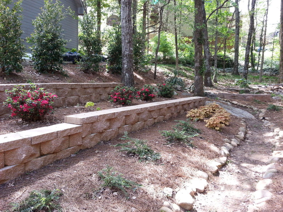 Medium sized rustic sloped fully shaded garden in Other with a retaining wall.