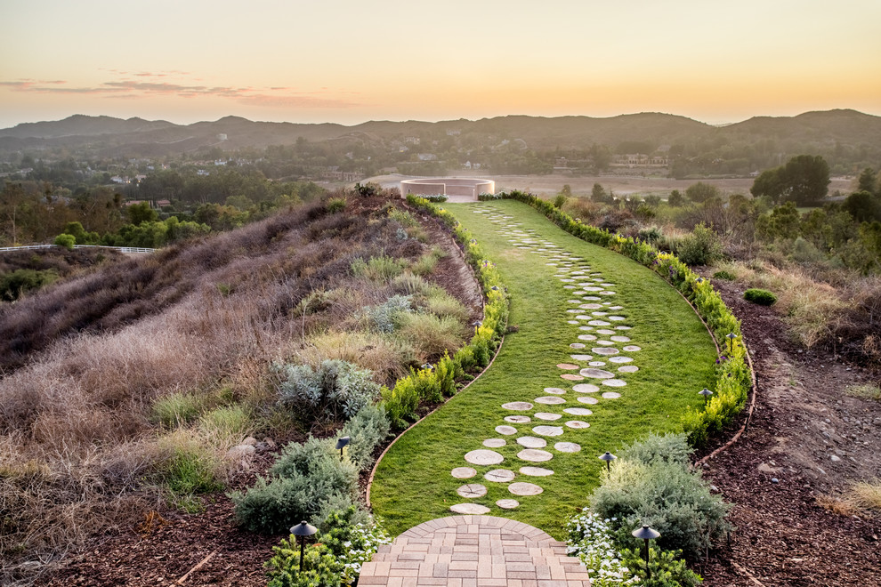 Design ideas for a mediterranean backyard garden path in Orange County.