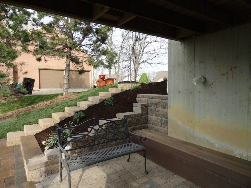 Immagine di un giardino contemporaneo con un muro di contenimento e pavimentazioni in cemento