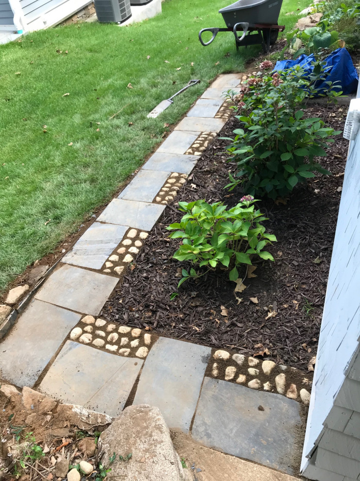 Small rustic side partial sun garden in New York with a garden path and natural stone paving.