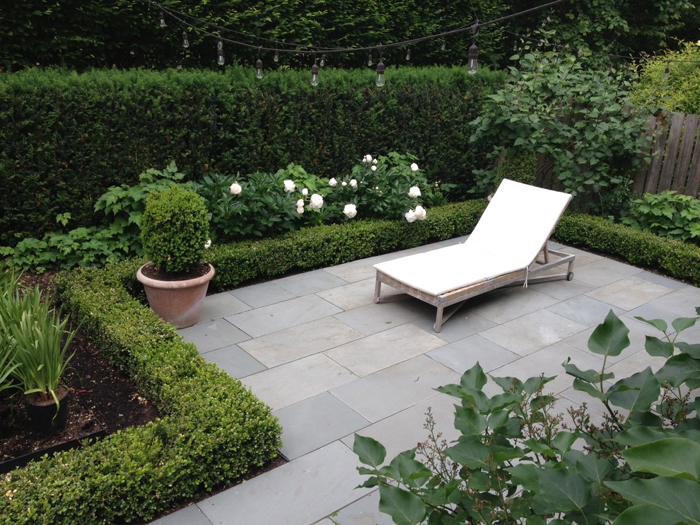 Design ideas for a mid-sized contemporary partial sun backyard stone formal garden in Seattle for summer.