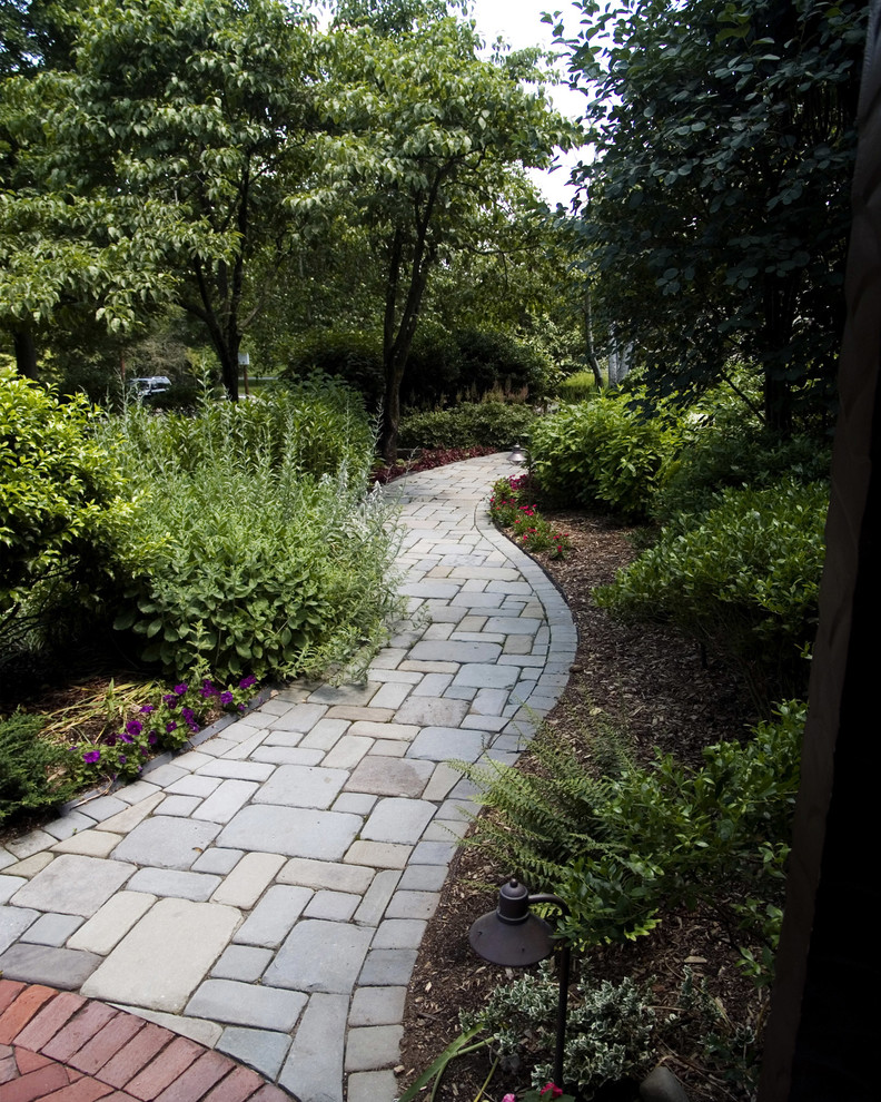 Medium sized traditional front formal fully shaded garden in Other with a garden path and natural stone paving.