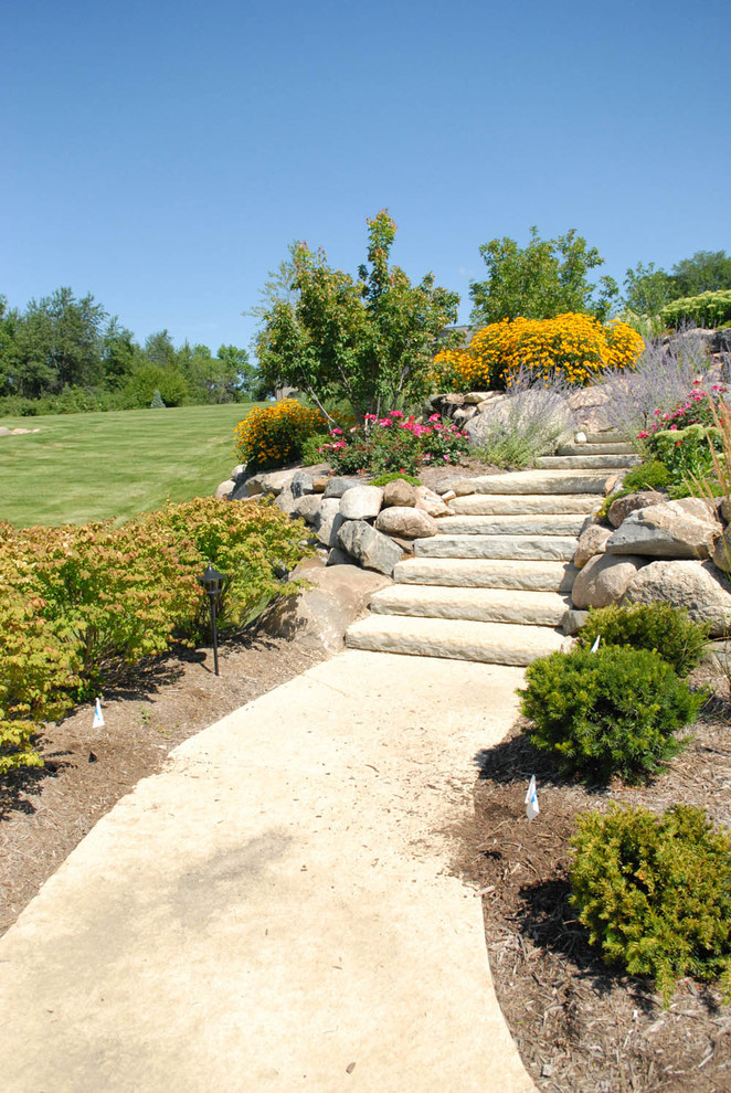 Photo of a large traditional full sun backyard concrete paver garden path in Other.