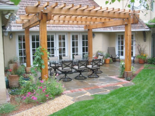 This is an example of a medium sized classic back formal partial sun garden in Cleveland with a potted garden and natural stone paving.
