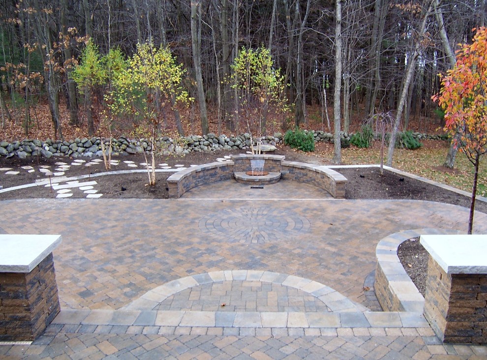 Inspiration for a backyard concrete paver water fountain landscape in Boston.