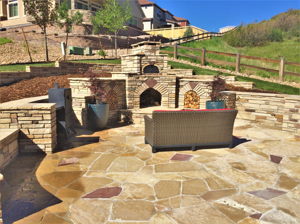 Large trendy backyard patio photo in Denver with a fireplace