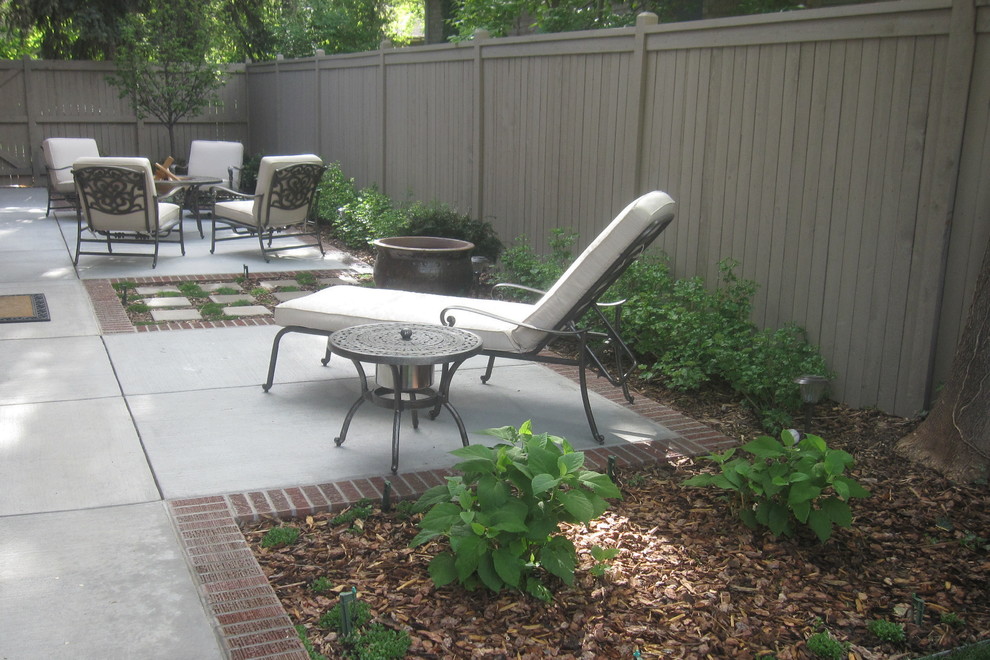 Photo of a large traditional side garden in Denver with brick paving.