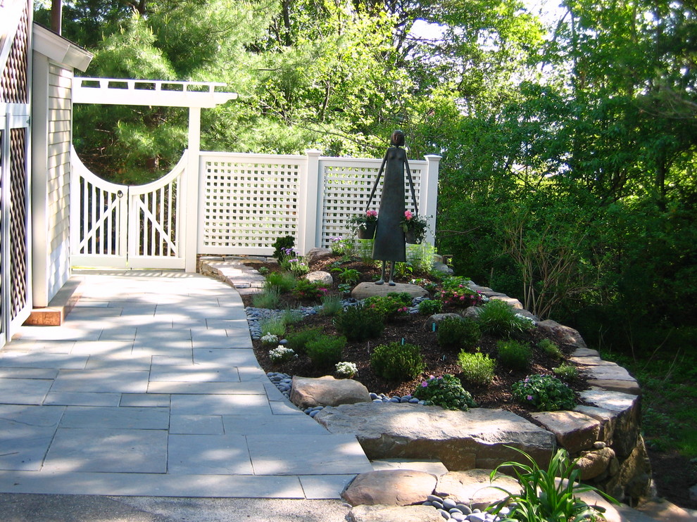 Classic side fully shaded garden in Portland Maine with natural stone paving.