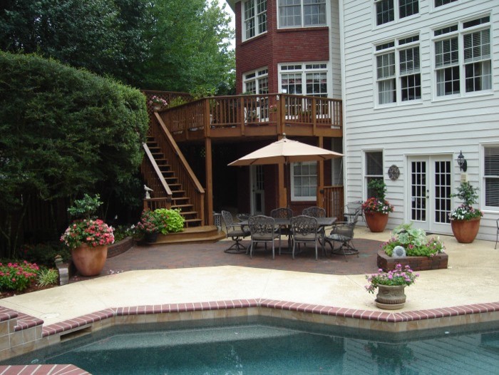 This is an example of a traditional full sun backyard concrete paver landscaping in Atlanta for summer.