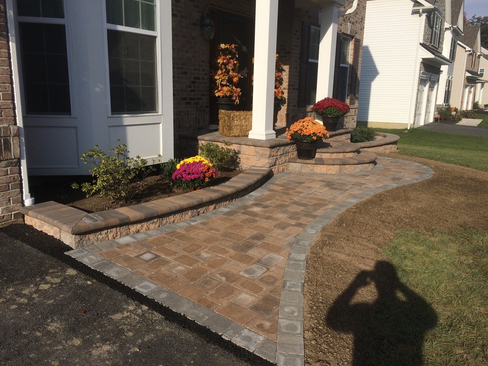 This is an example of a mid-sized rustic front yard brick garden path in Wilmington.