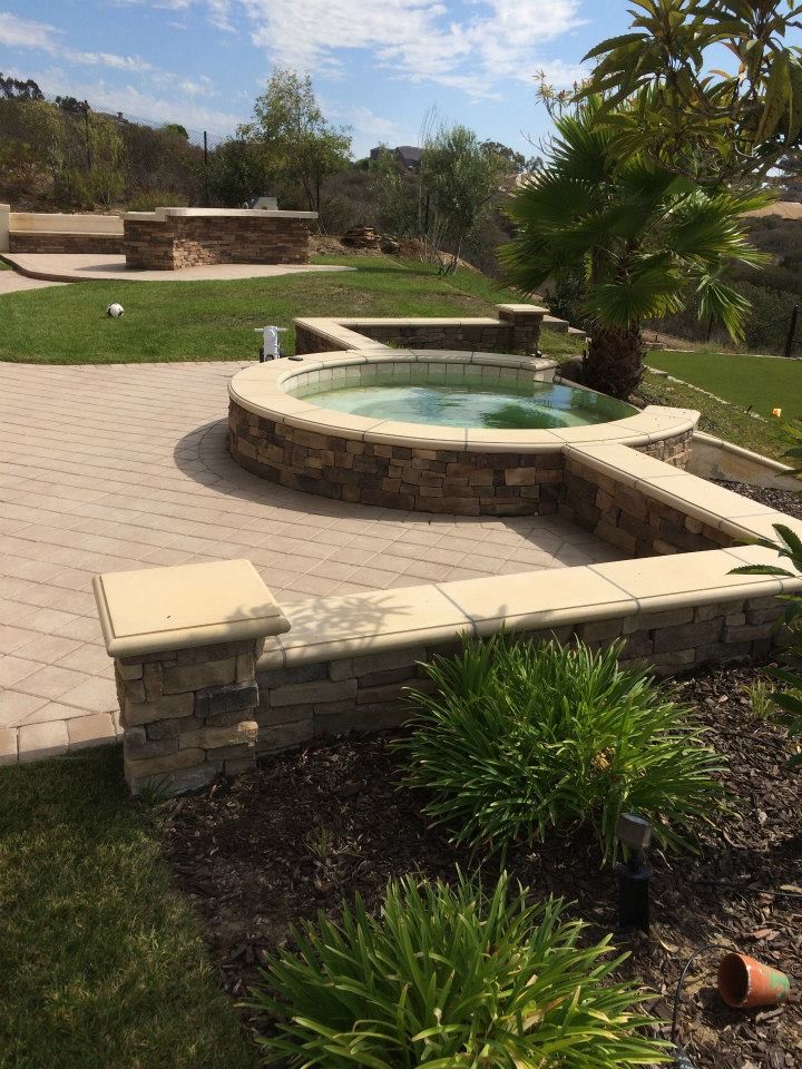 Photo of a large classic back partial sun garden in San Diego with brick paving.