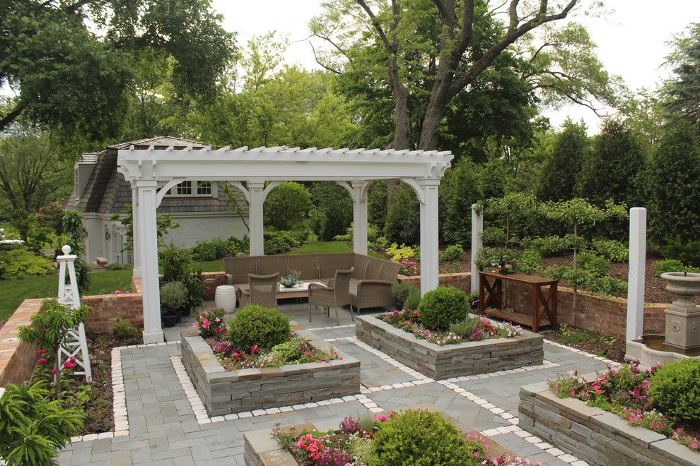 Modelo de jardín tradicional en patio trasero con adoquines de piedra natural