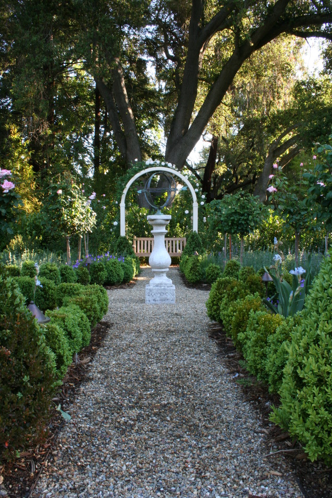 This is an example of a traditional backyard gravel formal garden in San Francisco.