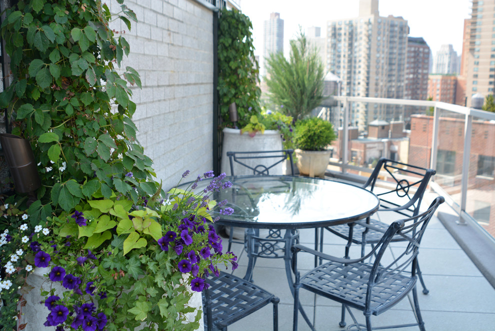 Photo of a small contemporary roof formal partial sun garden in New York with a potted garden.