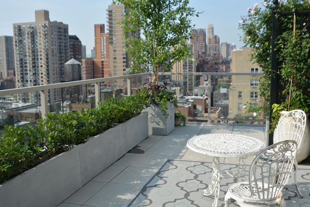 This is an example of a small contemporary roof formal partial sun garden in New York with a potted garden.