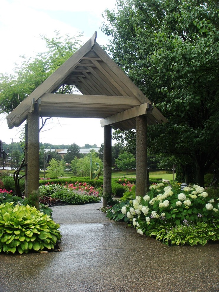 Inspiration for a large classic back formal partial sun pergola in Detroit with a garden path and natural stone paving.