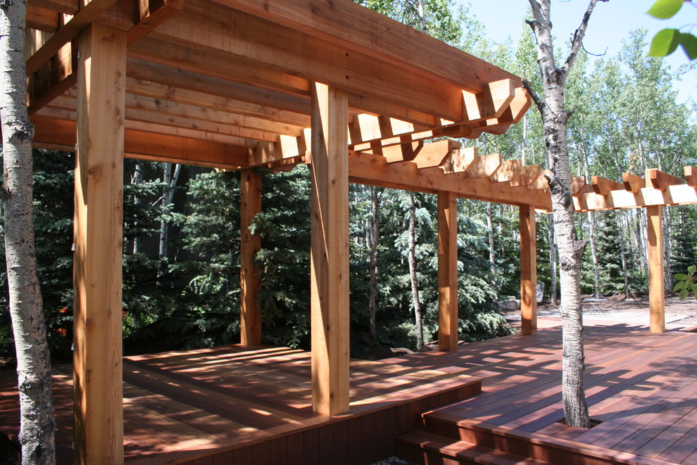 Large modern back fully shaded garden for summer in Calgary with an outdoor sport court and decking.
