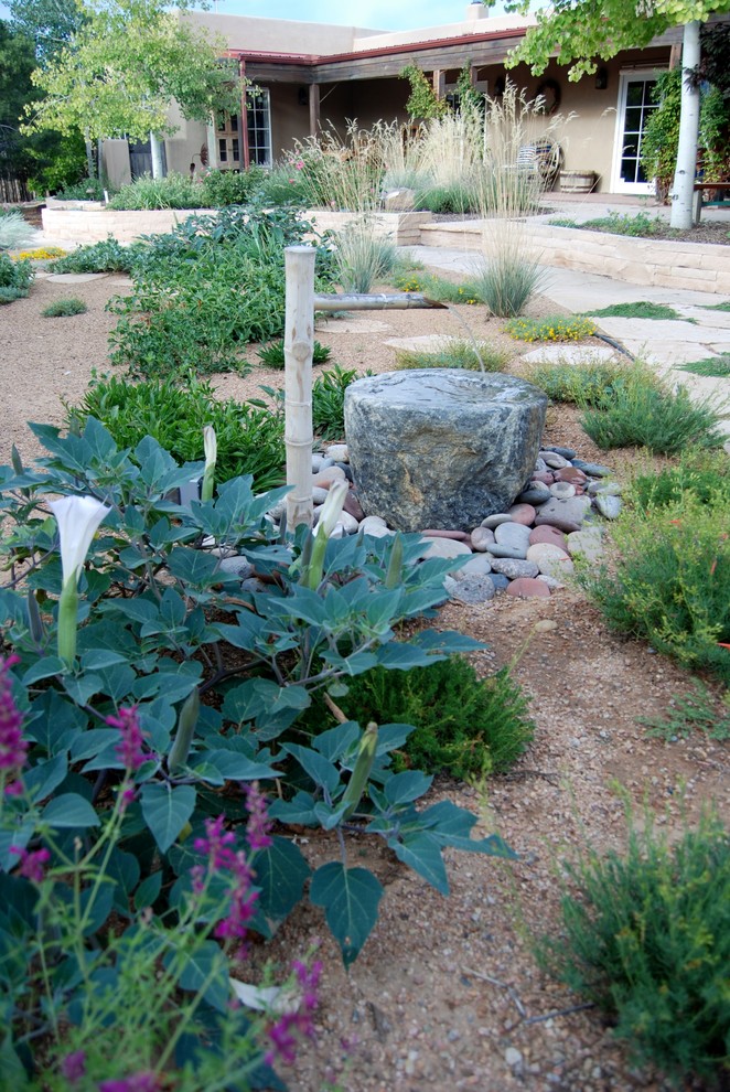 Ejemplo de jardín de secano mediterráneo pequeño en verano en patio trasero con exposición total al sol