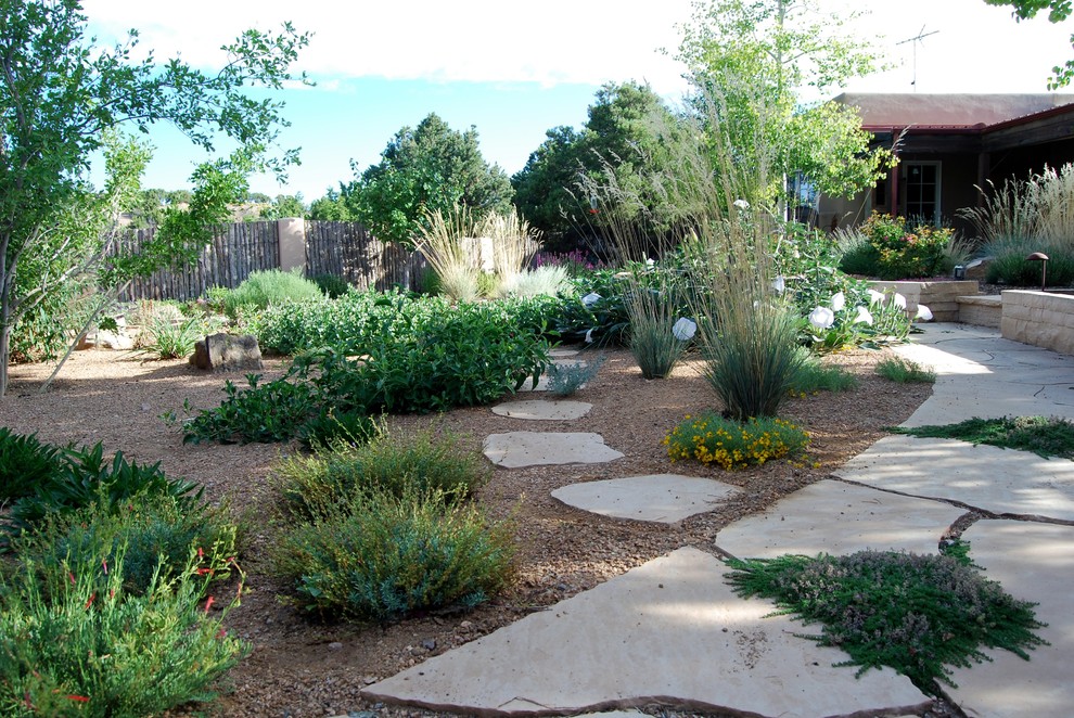 Design ideas for a small mediterranean drought-tolerant and full sun backyard landscaping in Albuquerque for summer.