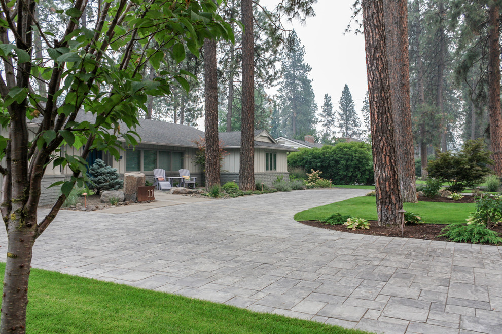 Photo of a large mid-century modern front yard concrete paver driveway in Seattle.