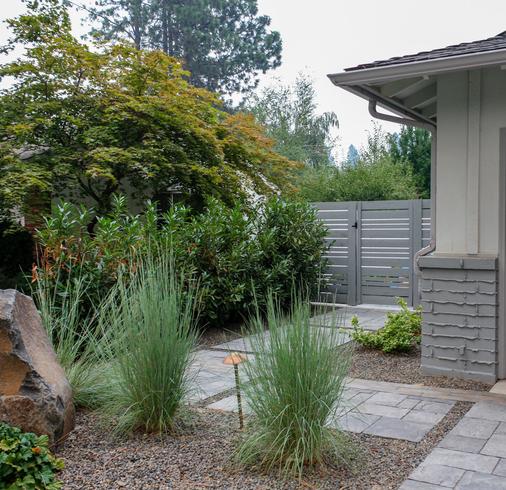 This is an example of a large mid-century modern side yard concrete paver driveway in Seattle.