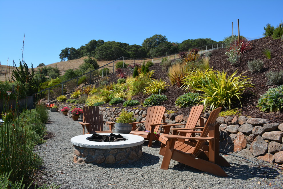 Inspiration for a large mediterranean drought-tolerant and full sun backyard gravel landscaping in San Francisco with a fire pit.