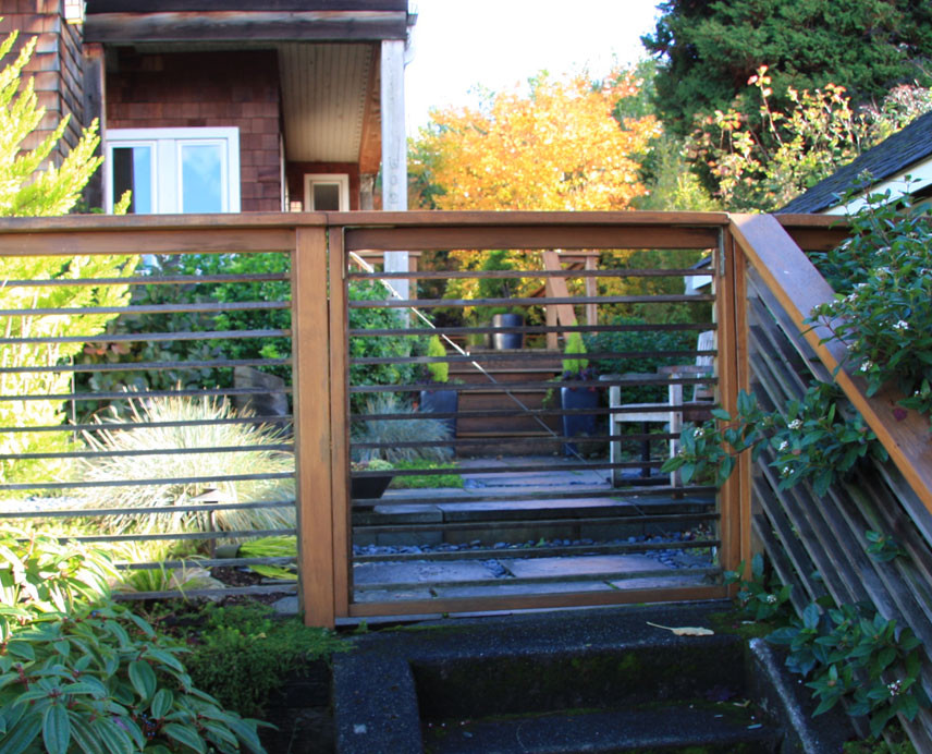 This is an example of a small modern partial sun backyard landscaping in Seattle with decking.