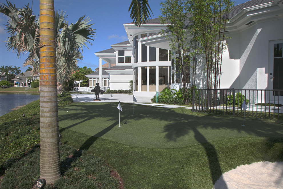 Immagine di un ampio campo sportivo esterno minimalista esposto in pieno sole dietro casa in estate con pavimentazioni in pietra naturale