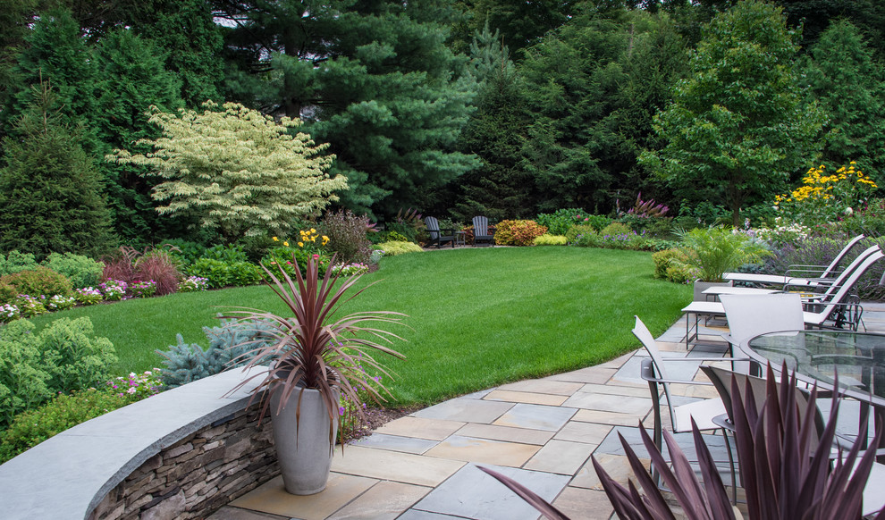 This is an example of a traditional back garden in New York with natural stone paving.
