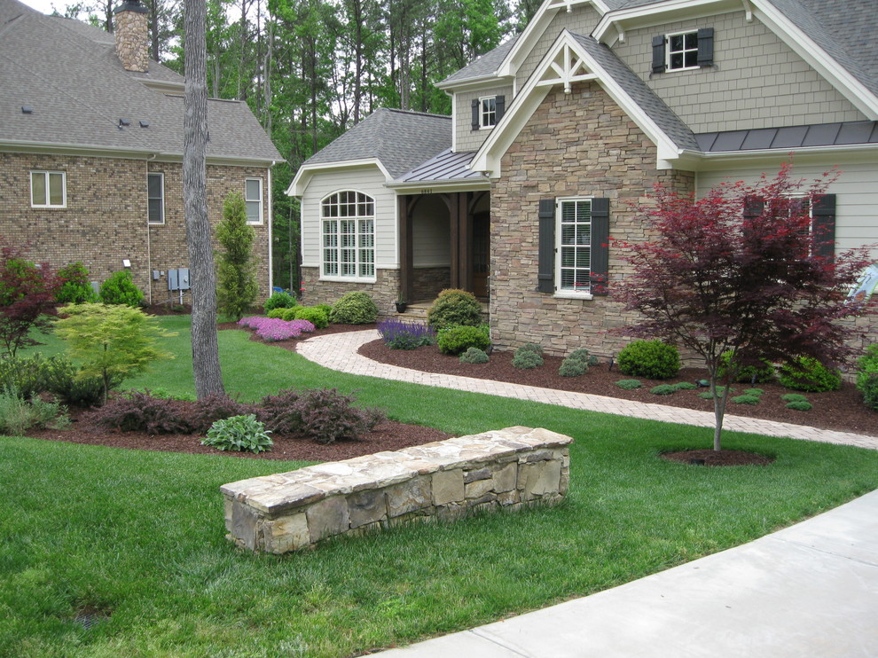 Medium sized classic front partial sun garden in Raleigh with concrete paving.