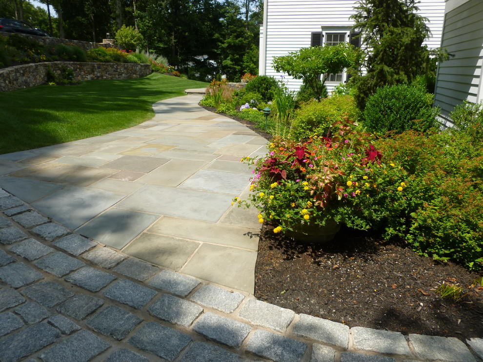Photo of a medium sized traditional side driveway partial sun garden for summer in New York with concrete paving.
