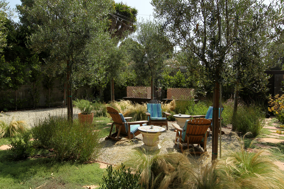 This is an example of a large mediterranean drought-tolerant and full sun backyard stone water fountain landscape in Los Angeles for summer.