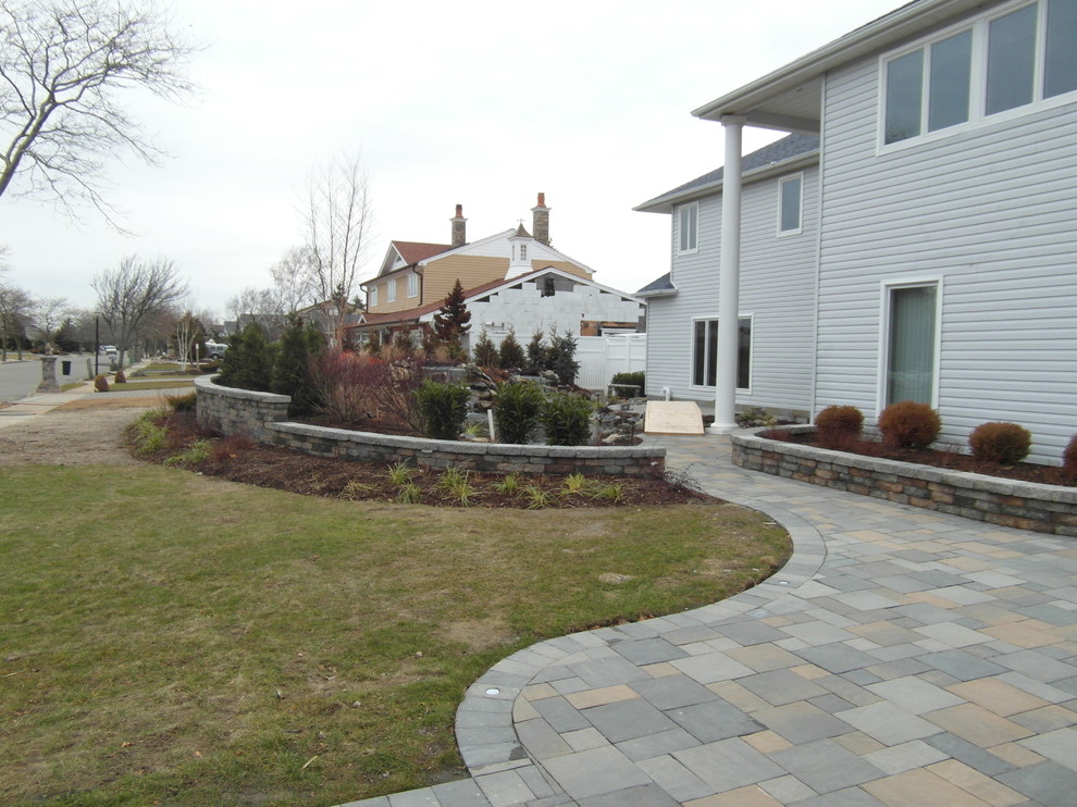 Medium sized coastal back partial sun garden for summer in New York with a water feature and concrete paving.