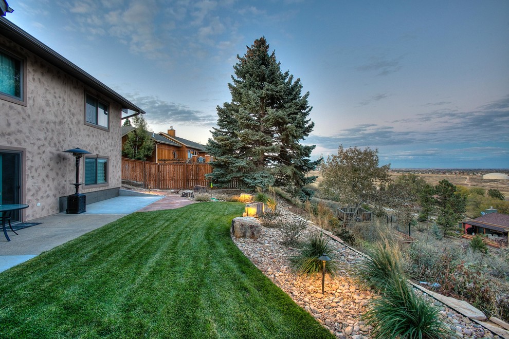 Large traditional back xeriscape garden in Denver.