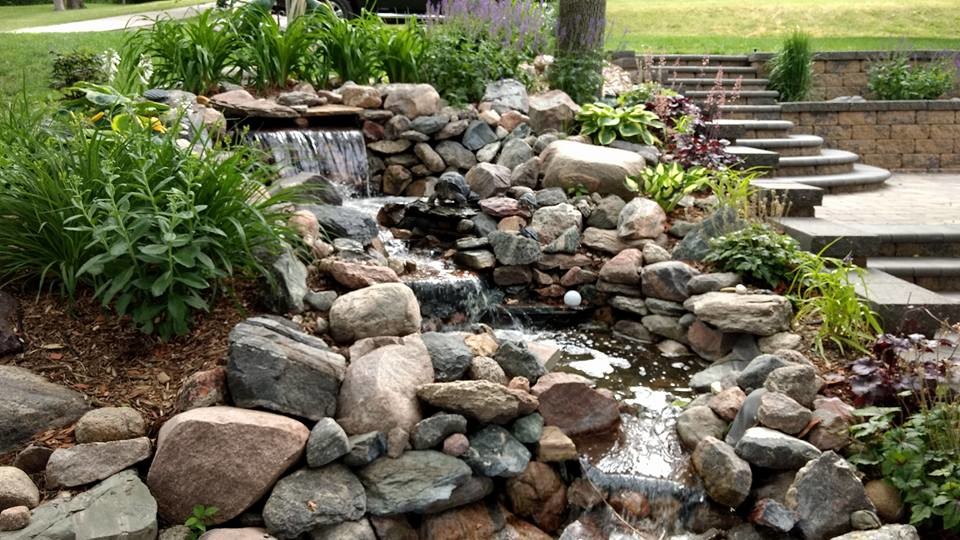Design ideas for a small rustic sloped partial sun garden for summer in Other with a pond.