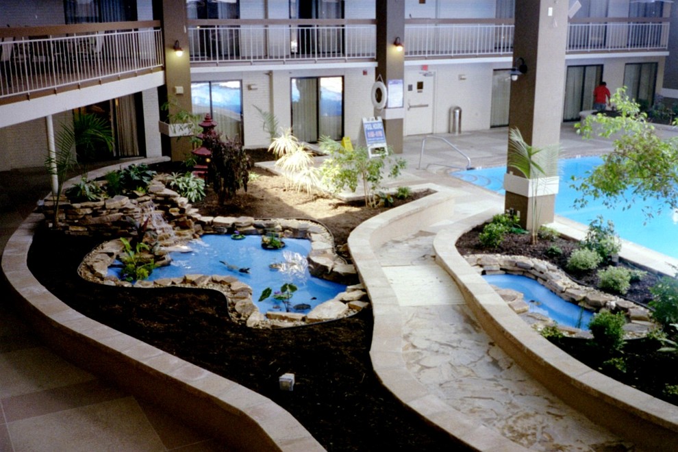 Photo of a mid-sized contemporary partial sun courtyard mulch water fountain landscape in Baltimore.